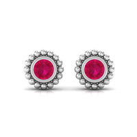 Beaded bezel set 1/4 CT ruby solitaire stud earring for women by Rosec Jewels with a classic gold finish.