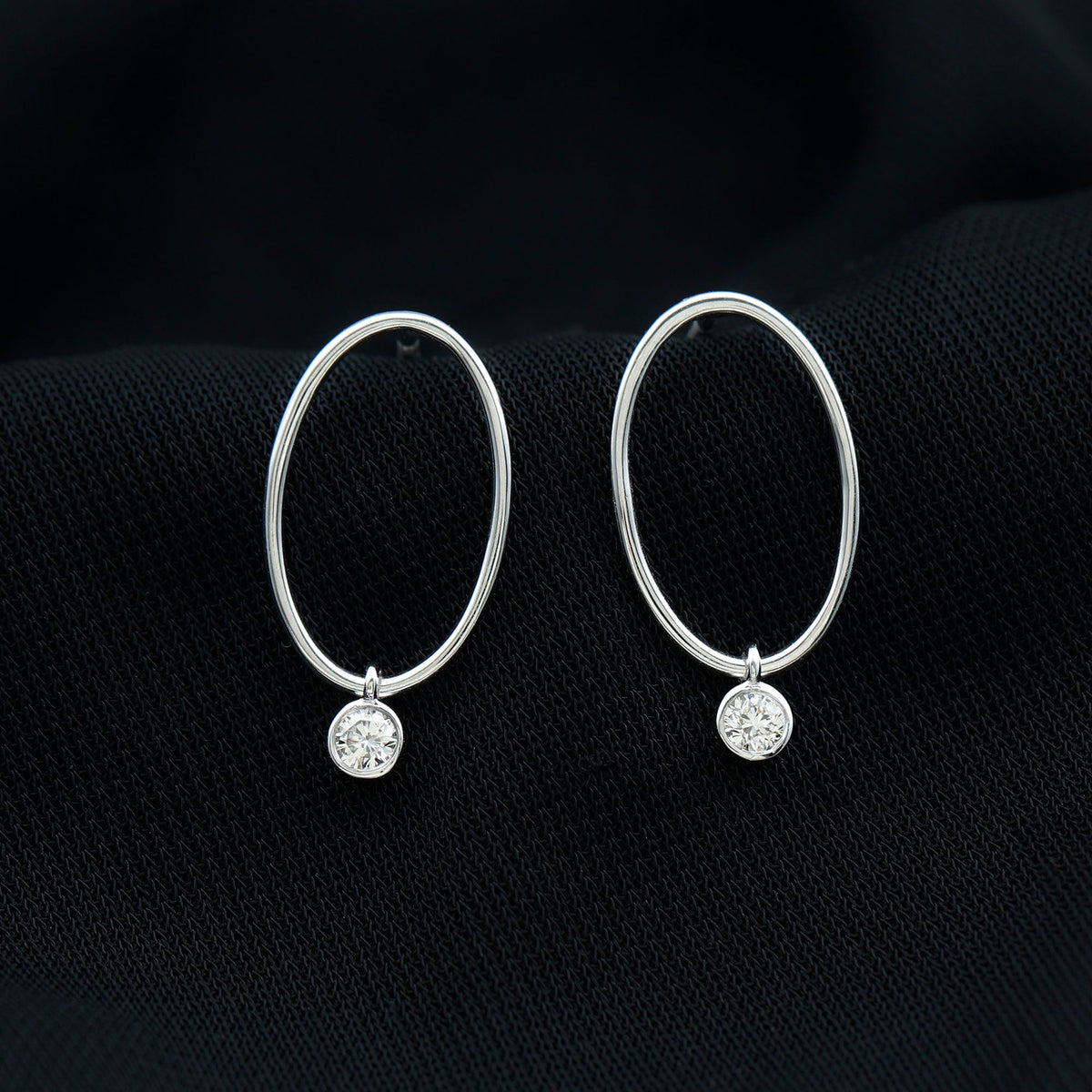 Bezel set moissanite front-facing hoop drop earrings by Rosec Jewels with sparkling stones and elegant design.
