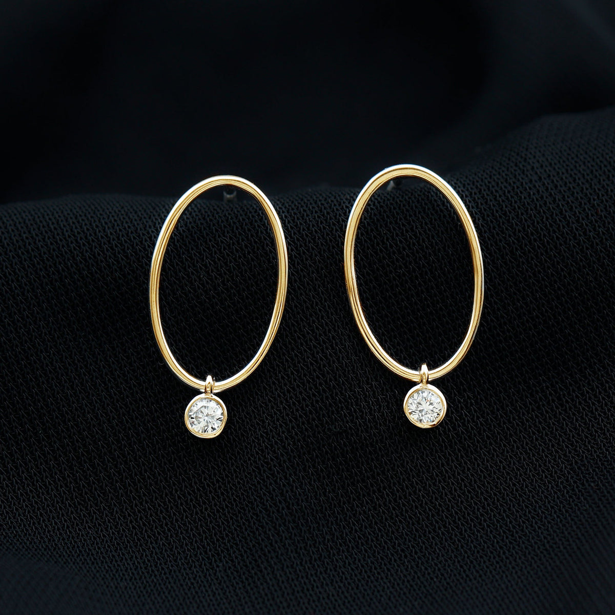Rosec Jewels bezel set moissanite front-facing hoop drop earrings shown in a close-up image.