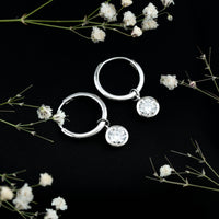 Bezel set 2 carat round moissanite drop hoop earrings by Rosec Jewels featuring sparkling gemstones and gold-tone metal.