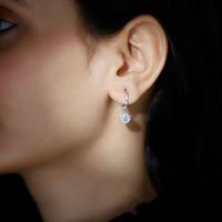 Bezel set moissanite and hinged hoop earrings by Rosec Jewels with sparkling stones and sleek gold finish.