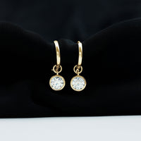 Bezel set moissanite and hinged hoop earrings by Rosec Jewels, showcasing sparkling stones and sleek gold design.
