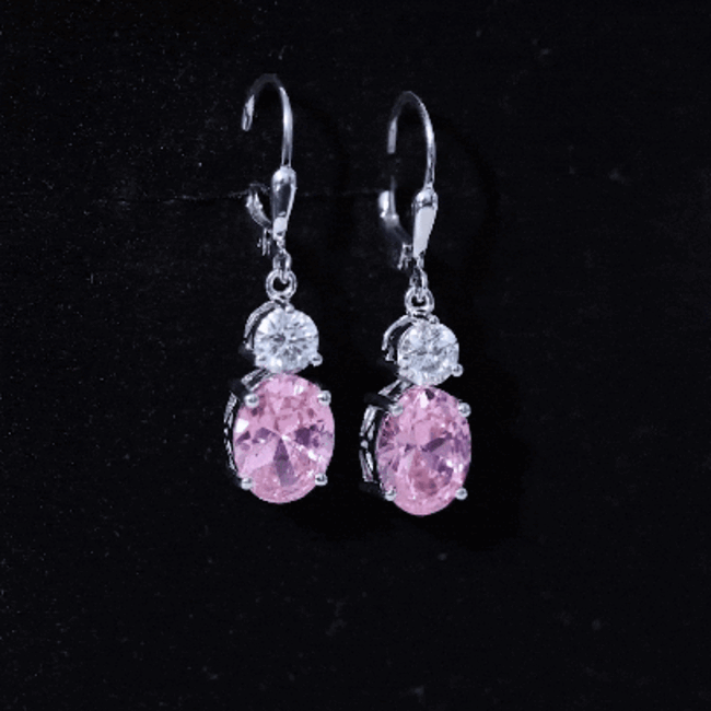 Oval lab-grown pink sapphire drop hoop earrings by Rosec Jewels featuring 8 carats of pink sapphires in a sterling silver setting.