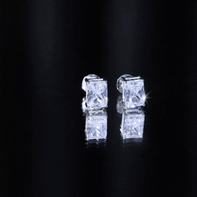 Rosec Jewels cubic zirconia stud earrings with 3.7 carat emerald cut clear stones, set in a classic earring design.