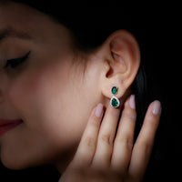 Lab-created emerald dangle earrings with moissanite stones from Rosec Jewels, featuring elegant gold-toned metal and sparkling gemstone accents.