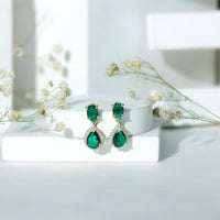 Lab-created emerald and moissanite dangle earrings by Rosec Jewels featuring classic design and sparkling gemstone accents.