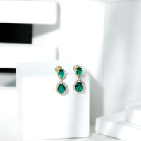 Lab-created emerald and moissanite dangle earrings by Rosec Jewels featuring elegant, sparkling gemstone accents and classic design.