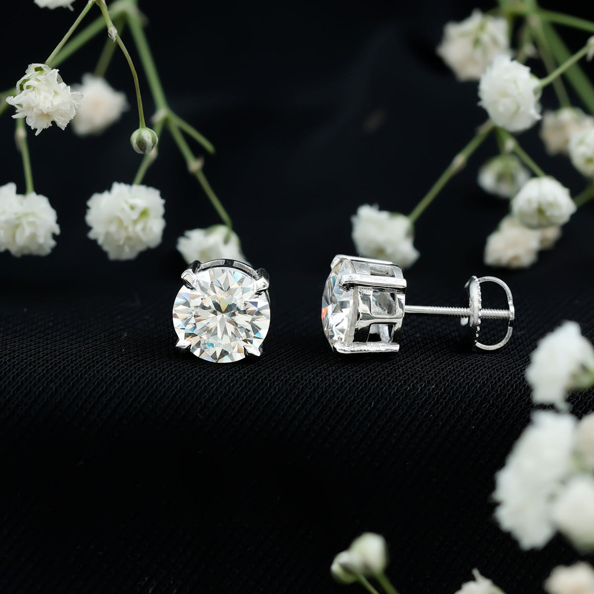 Certified 4-carat moissanite stud earrings in silver with a classic design, featuring sparkling gemstone accents.