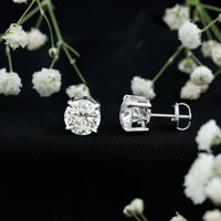 Certified 4-carat moissanite stud earrings in silver with a classic design, featuring sparkling gemstone accents.