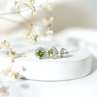 Rosec Jewels classic peridot and diamond stud earrings for women, showcasing green gemstones and sparkling diamonds.