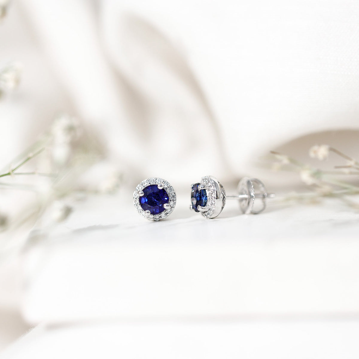 Real 1.9 carat blue sapphire and diamond halo stud earrings by Rosec Jewels featuring sparkling gemstones and elegant design.