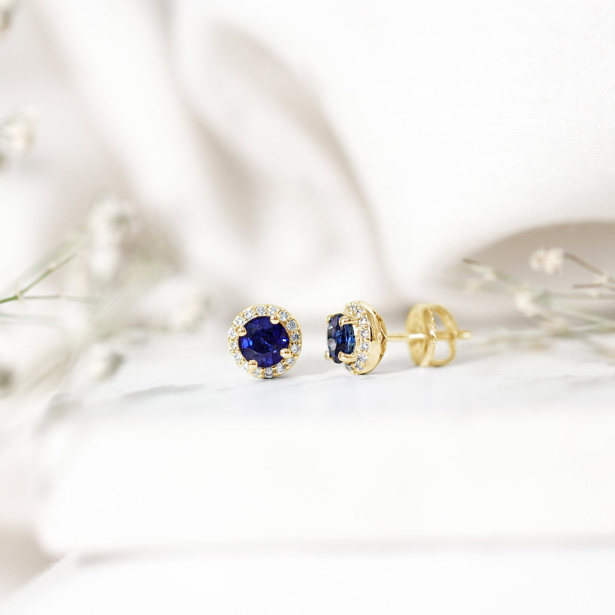 Real 1.9 carat blue sapphire and diamond halo stud earrings by Rosec Jewels featuring elegant gemstone and diamond detailing.