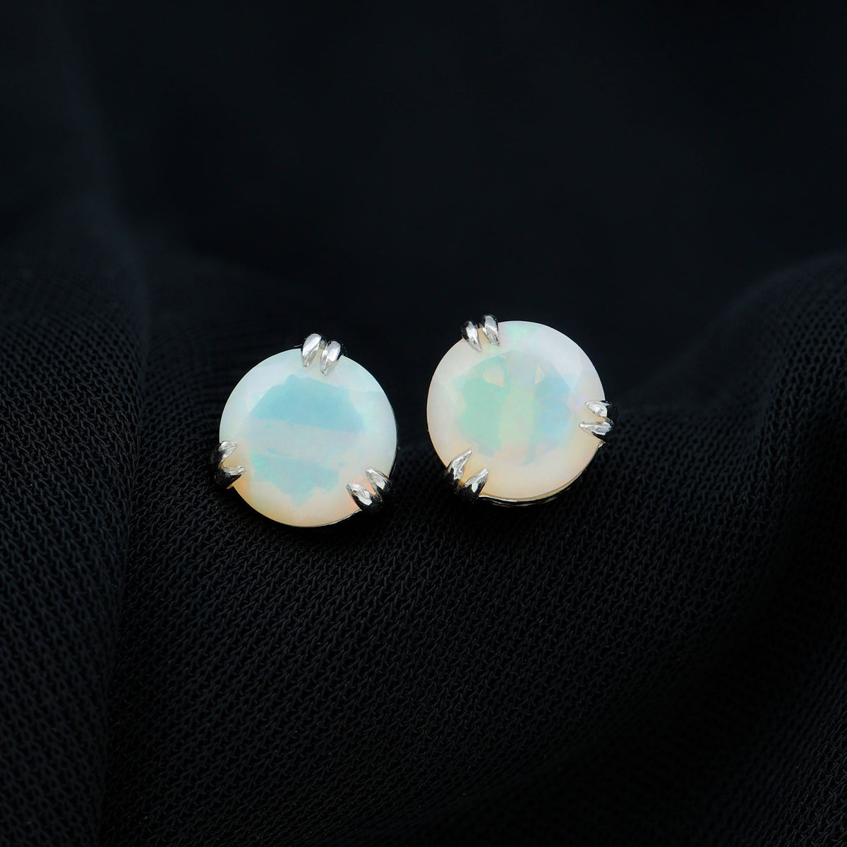4 carat Ethiopian opal solitaire stud earrings with double prong setting by Rosec Jewels, showcasing vibrant, iridescent gemstone in a classic design.