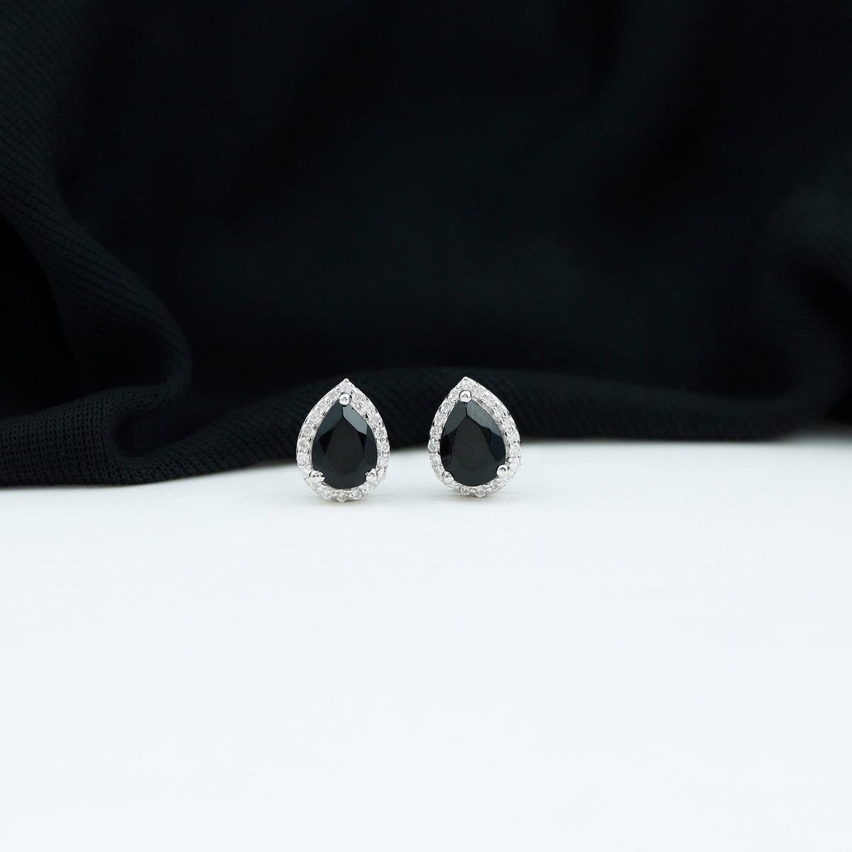 Pear cut black onyx and diamond halo stud earrings by Rosec Jewels featuring 2 carats of elegance.