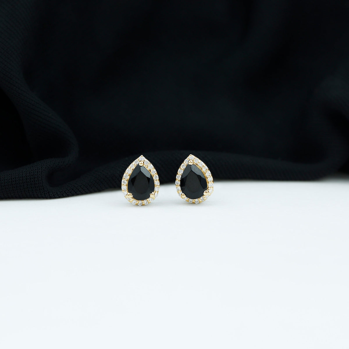 Pear cut black onyx and diamond halo stud earrings by Rosec Jewels, featuring elegant gemstone and sparkle details.