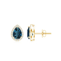 London Blue Topaz teardrop stud earrings with diamond halo by Rosec Jewels, featuring sparkling blue gemstones and elegant design.