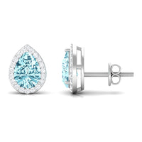 Pear-shaped aquamarine stud earrings with diamond halo by Rosec Jewels, featuring natural blue aquamarine stones and sparkling diamonds.