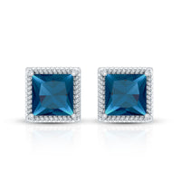 Rosec Jewels 2 Carat princess cut London Blue Topaz stud earrings with silver settings on a white background.