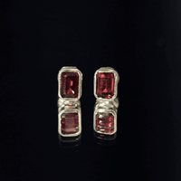 Yellow bezel-set 1.4 CT emerald cut garnet solitaire stud earrings by Rosec Jewels showcasing their elegant design and vibrant color.