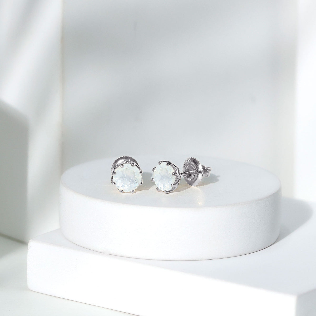 Rosec Jewels 6mm moonstone solitaire stud earrings, elegant jewelry with sparkling moonstones and silver settings.