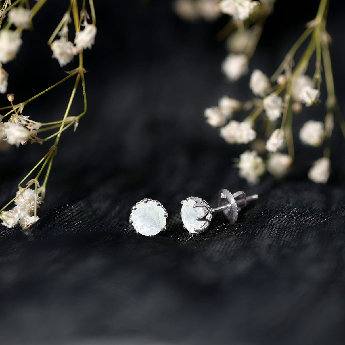 Rosec Jewels 6mm moonstone solitaire stud earrings with decorative design, showcasing sparkling moonstone gemstones on a sleek earring setting.