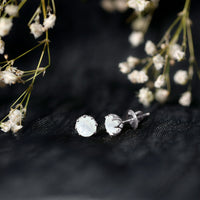 Rosec Jewels 6mm moonstone solitaire stud earrings with decorative design, showcasing sparkling moonstone gemstones on a sleek earring setting.