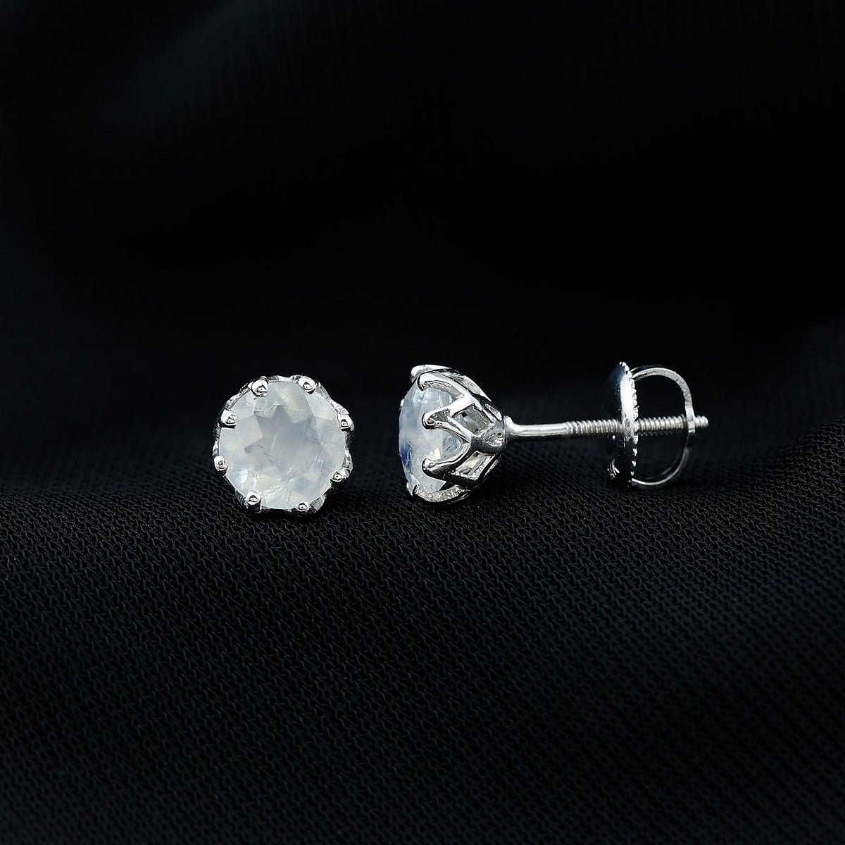 Sixmm moonstone solitaire stud earrings by Rosec Jewels featuring a decorative set design with polished gemstone and silver setting.