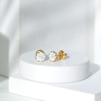 Six millimeter moonstone solitaire stud earrings by Rosec Jewels, featuring elegant, round-cut moonstones set in classic earring design.