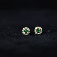Minimalist emerald and diamond halo stud earrings by Rosec Jewels, featuring green gemstones and sparkling accents.
