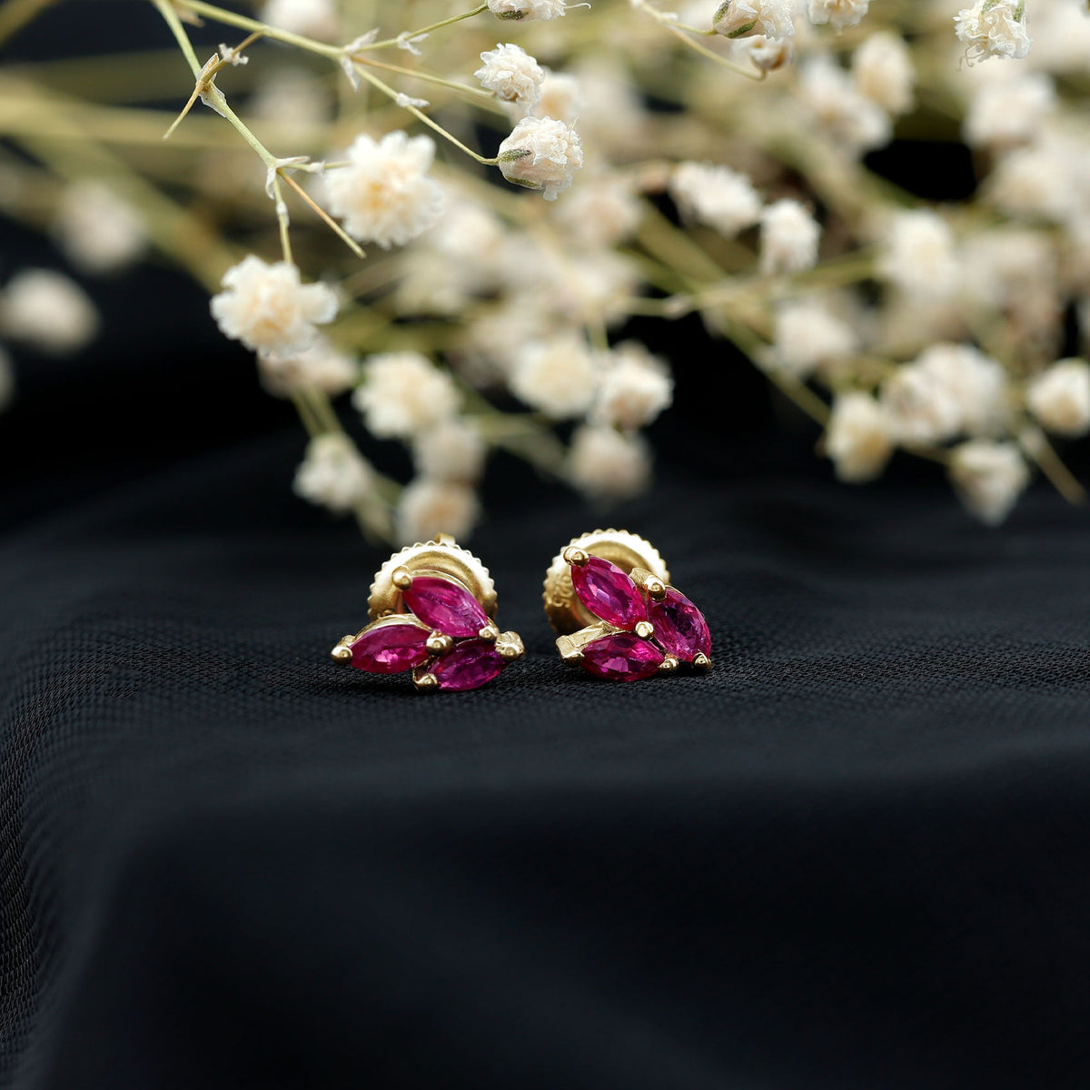 Marquise shape ruby leaf stud earrings for women by Rosec Jewels, featuring vibrant red rubies and delicate leaf design.