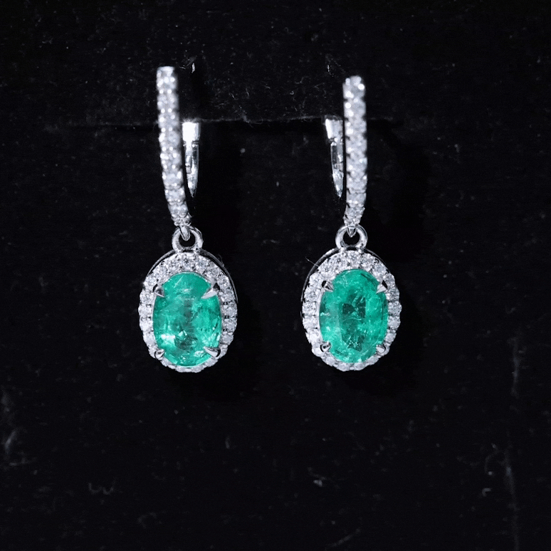 Oval emerald hoop earrings with diamond halo by Rosec Jewels, showcasing yellow gold earrings with sparkling gemstone accents.