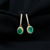 Oval shape emerald hoop earrings with diamond halo from Rosec Jewels, featuring elegant drop design and sparkling accents.