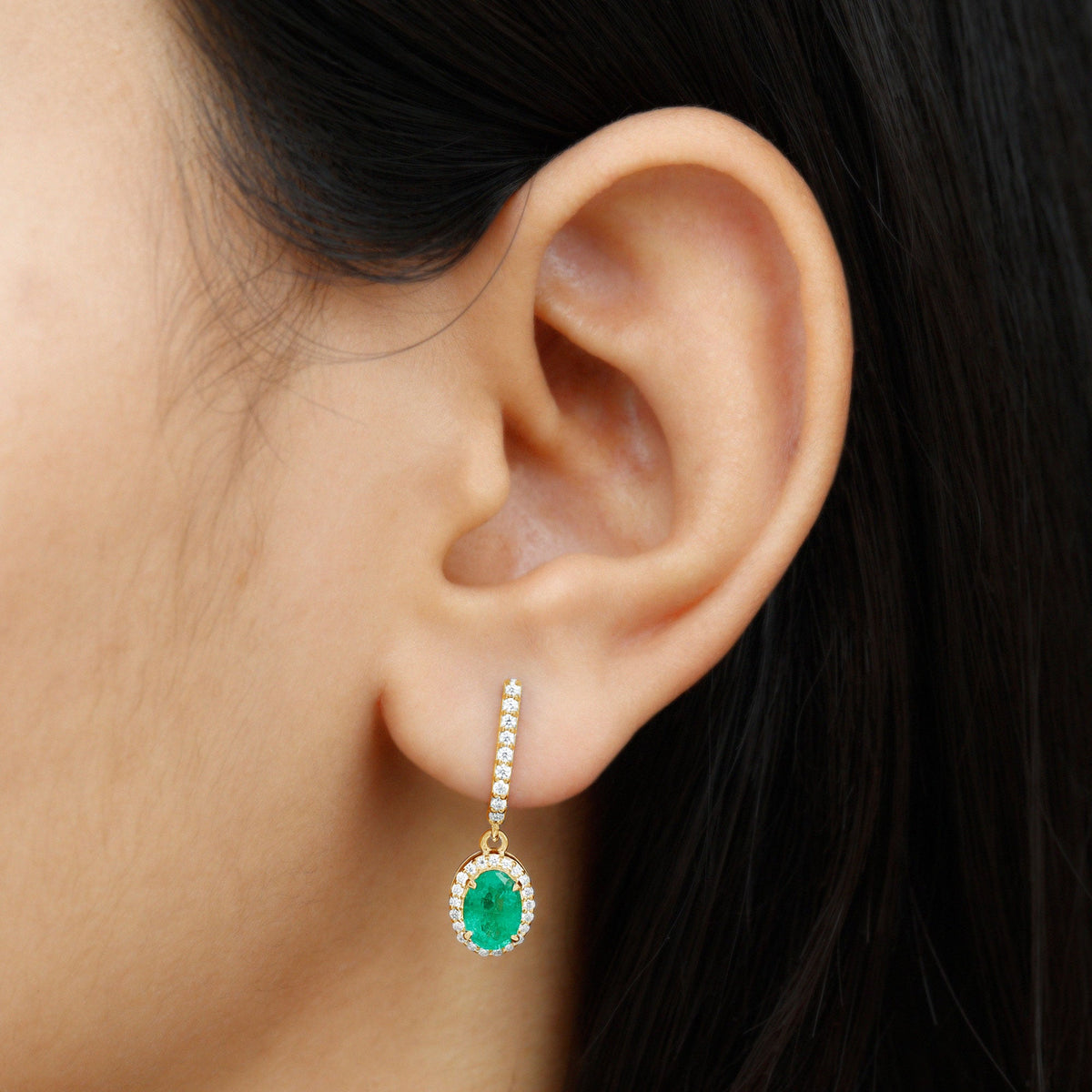 Oval emerald hoop drop earrings with diamond halo featuring Rosec Jewels, showcasing elegant gemstone and sparkling diamond details.
