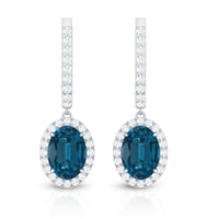 Oval London Blue Topaz and diamond hoop drop earrings by Rosec Jewels featuring 2.2 carats of vibrant blue topaz and sparkling diamonds.