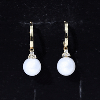 Round freshwater pearl and diamond hoop drop earrings by Rosec Jewels featuring gold hoops with elegant pearl and diamond accents.