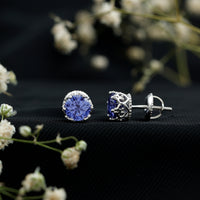 Created blue sapphire solitaire crown stud earrings by Rosec Jewels, showcasing sparkling blue gemstones in a classic setting.