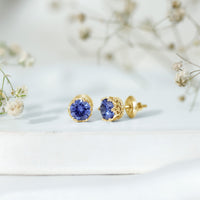 Created blue sapphire solitaire crown stud earrings by Rosec Jewels, featuring sparkling blue sapphires in elegant gold settings.