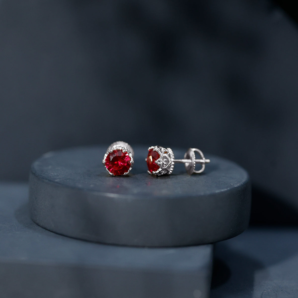 Lab-created ruby solitaire stud earrings by Rosec Jewels featuring 2.7 carat round-cut rubies with a classic earring setting.