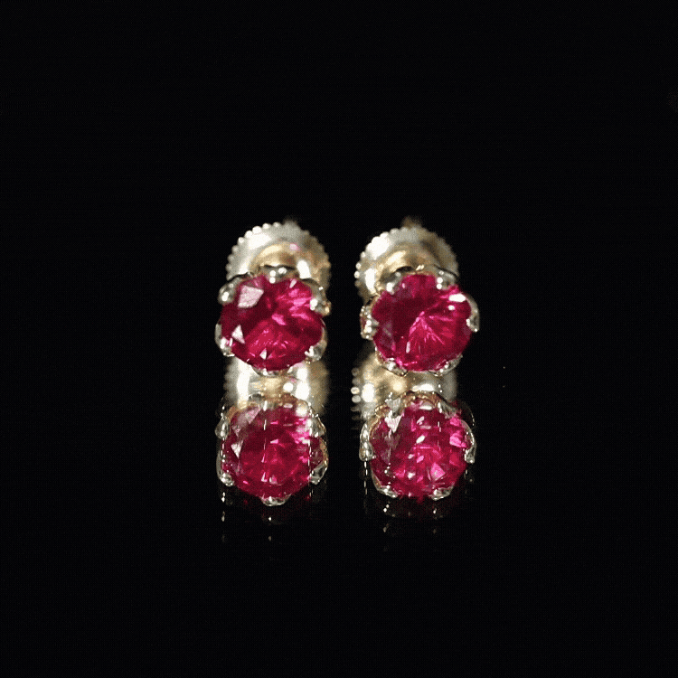 Pair of 2.7 carat round cut lab-created ruby stud earrings for women by Rosec Jewels, showcasing vibrant red gemstones.