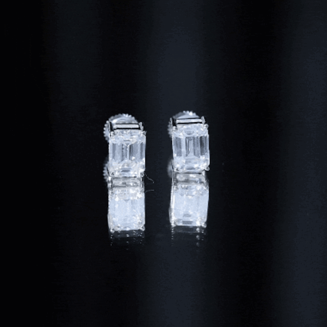 Certified 3.7 carat Moissanite emerald cut stud earrings by Rosec Jewels featuring sparkling white gemstones and a sleek earring setting.
