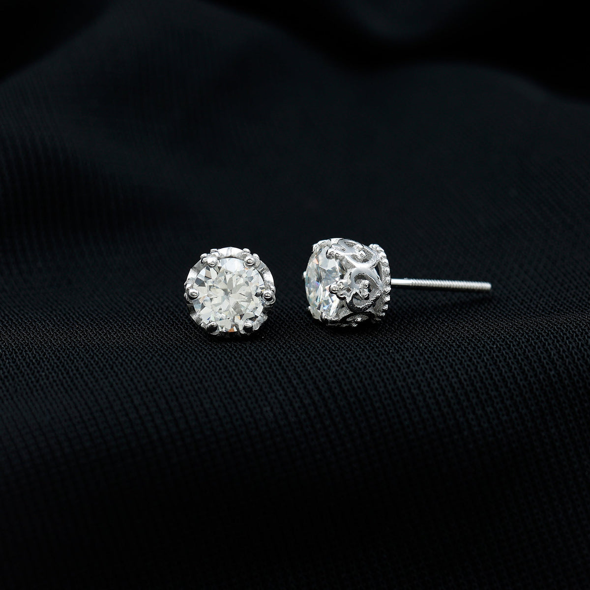 Round 1.97 carat moissanite stud earrings in crown setting, featuring sparkling gemstones and polished metal for elegant style.