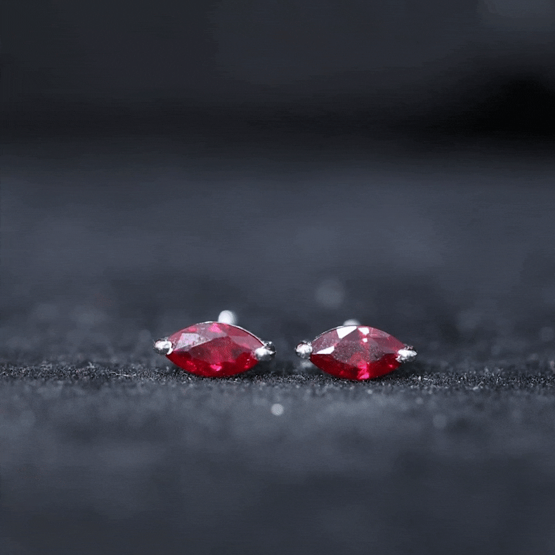 Marquise cut lab-grown ruby stud earrings by Rosec Jewels featuring 1.5 carats of vibrant red rubies in a classic earring design.
