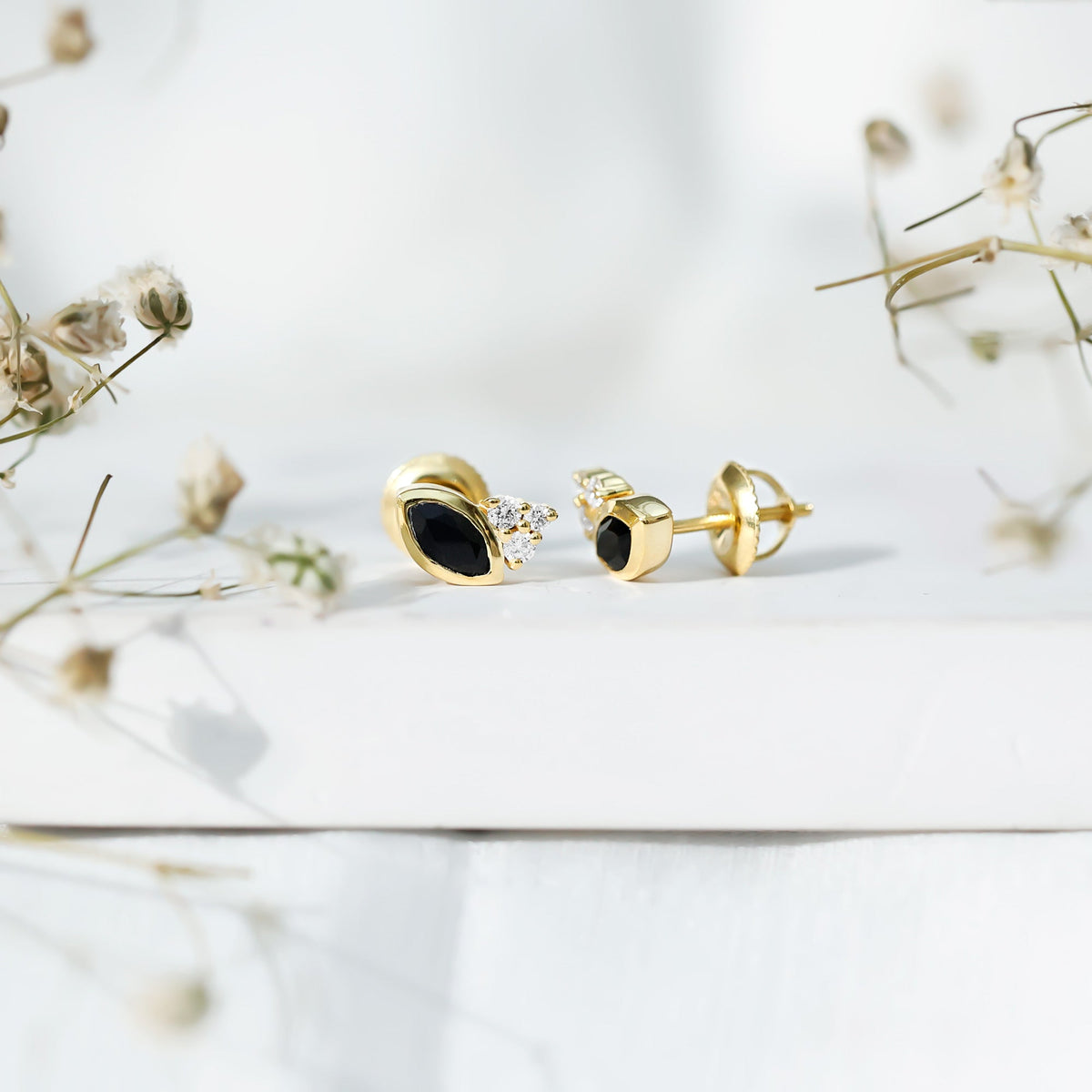 Marquise shape 0.7 carat lab-grown black and white diamond stud earrings by Rosec Jewels displayed on a white background.