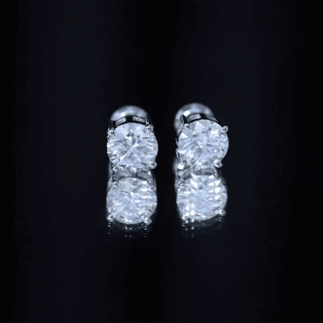 Yellow 2.7 carat round moissanite stud earrings in claw setting by Rosec Jewels, close-up view showing sparkling gemstones.