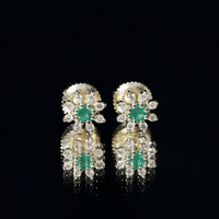 Natural emerald and diamond floral stud earrings from Rosec Jewels featuring intricate gemstone settings and elegant design.