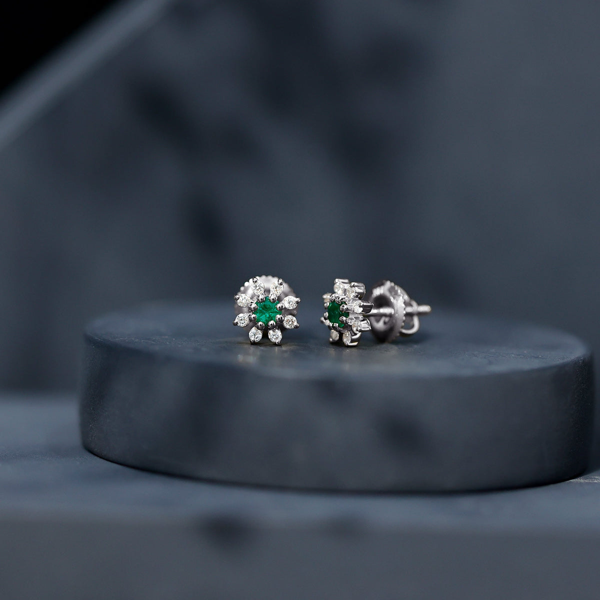 Natural emerald and diamond floral stud earrings by Rosec Jewels, featuring vibrant green emeralds and sparkling diamonds.