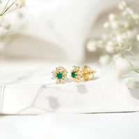 Natural emerald and diamond floral stud earrings by Rosec Jewels, featuring vibrant green emeralds and sparkling diamonds.