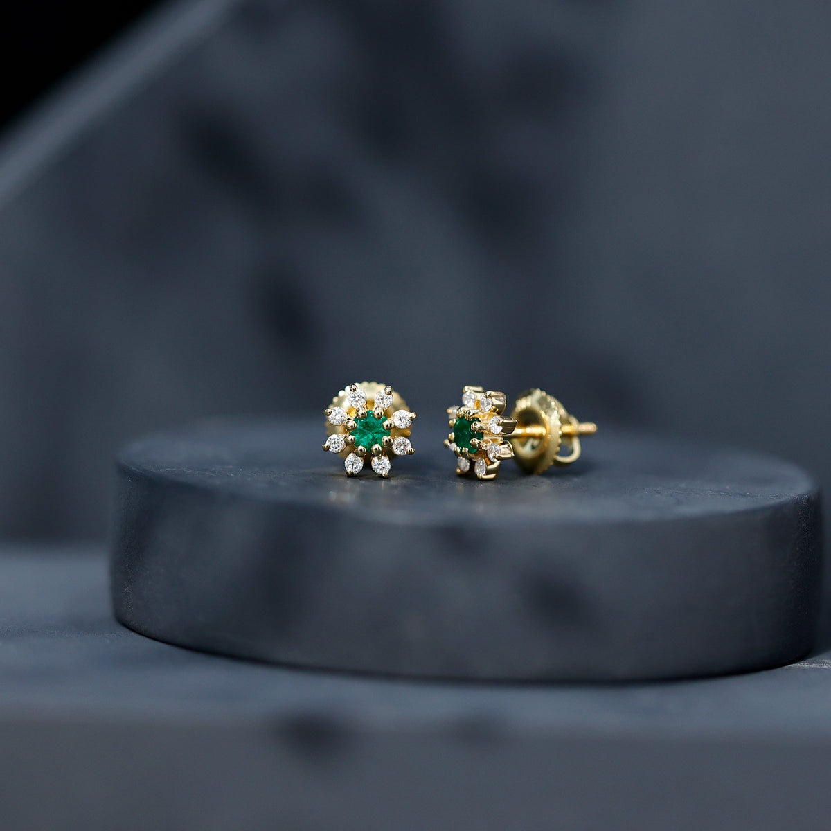 Natural emerald and diamond floral stud earrings from Rosec Jewels featuring vibrant green gemstones and sparkling accents.