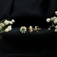 Natural emerald and diamond floral stud earrings by Rosec Jewels featuring vibrant green emeralds and sparkling diamonds.