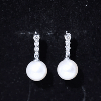 Yellow gold freshwater pearl drop earrings with diamond accents from Rosec Jewels, showcasing elegant jewelry design.